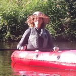 woman with hat on kayak on a pond