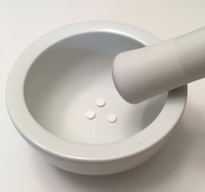 pills in a mortar and pestle