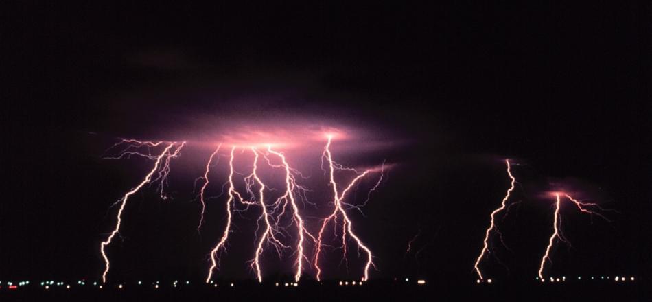 lightning striking in night sky