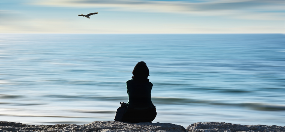 woman sitting at ocean