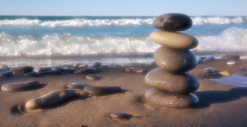 pile of rocks balanced on a beach