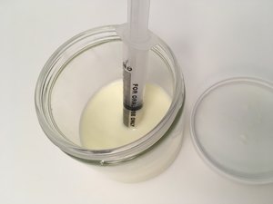 syringe in jar of milk