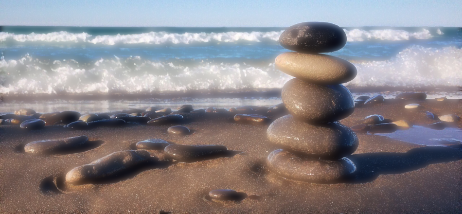 pile of rocks balanced on a beach