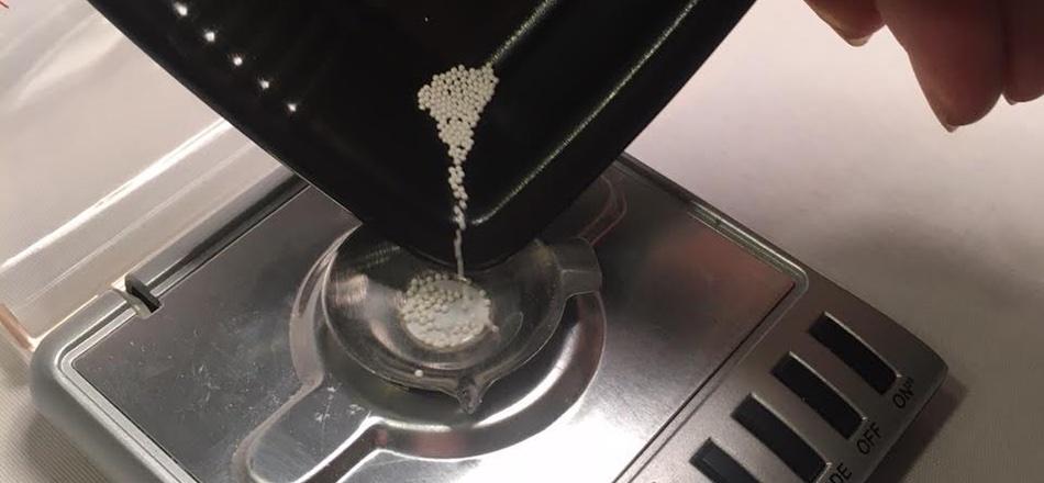 pouring beads onto a digital scale