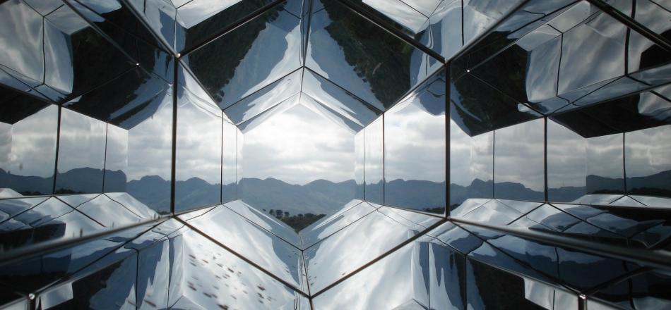 opening onto a light sky with various mirrors causing reflections around the perimeter